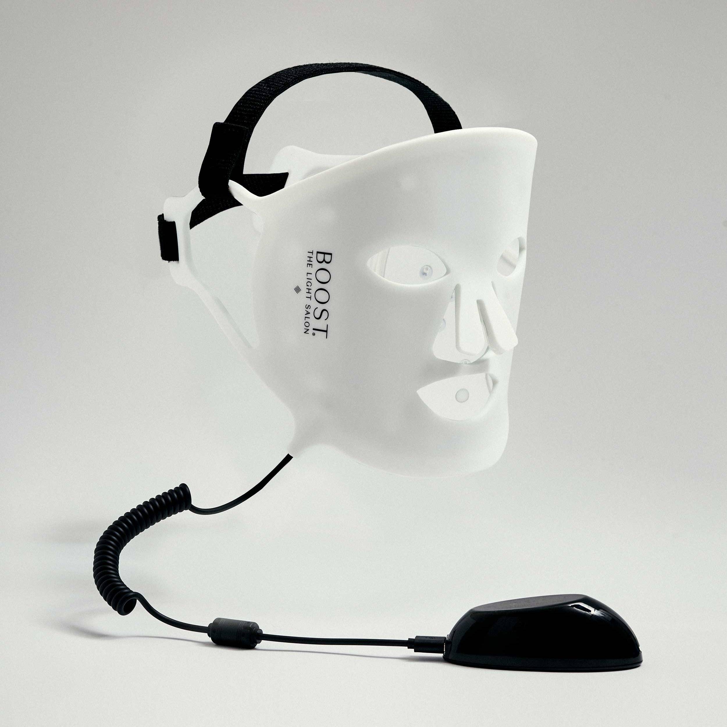 White light therapy mask with black cord and control unit.